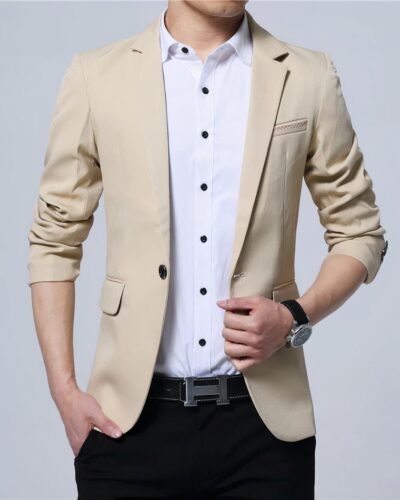 Un blazer beige porté par un homme avec une chemise blanche et un pantalon noir